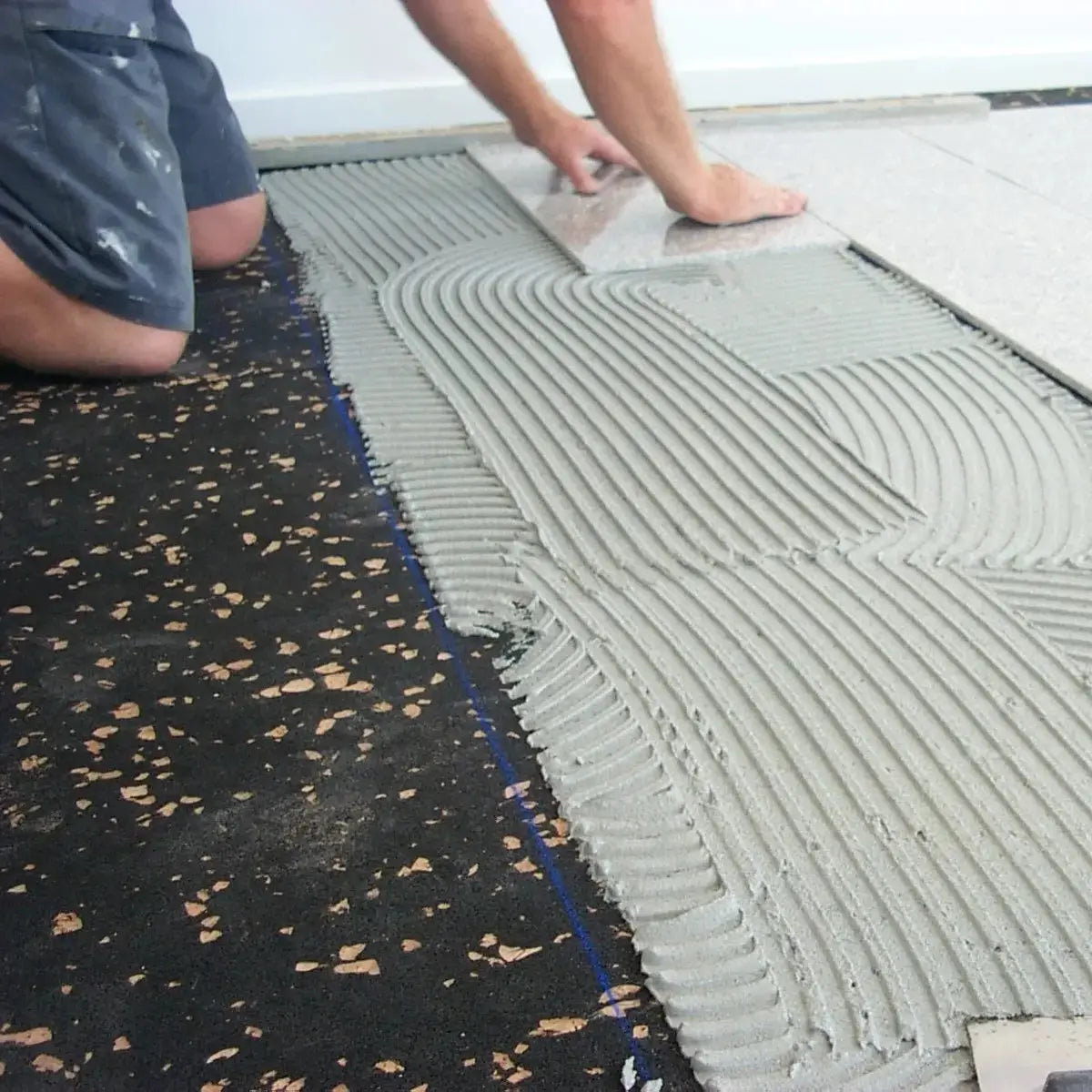A1 AcoustaMat Underlay being laid under ceramic tiles