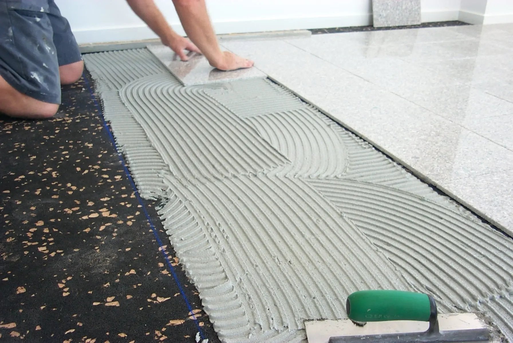 A1 AcoustaMat Underlay being laid under ceramic tiles