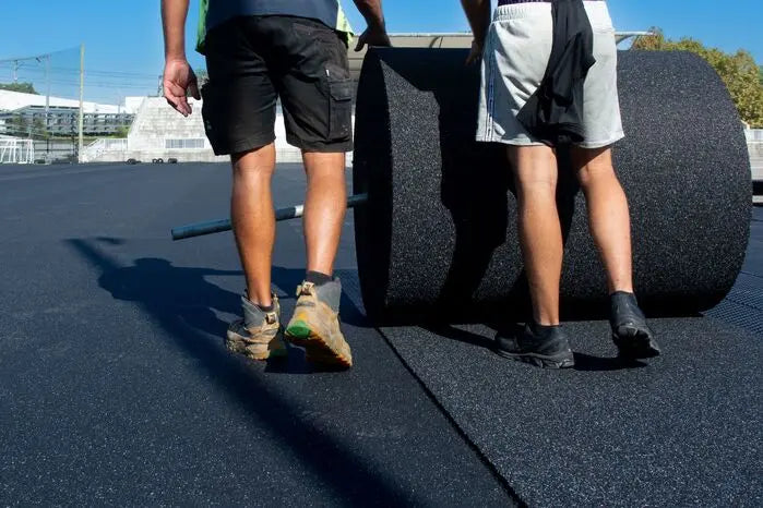 A1 AeroRoll Rubber Shock Pad being installed on a soccer pitch