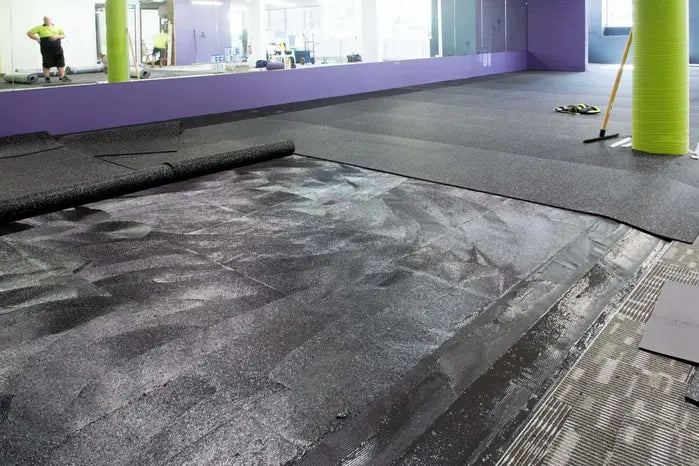A1 Olympact Rubber Underlay installation under rolled rubber gym flooring
